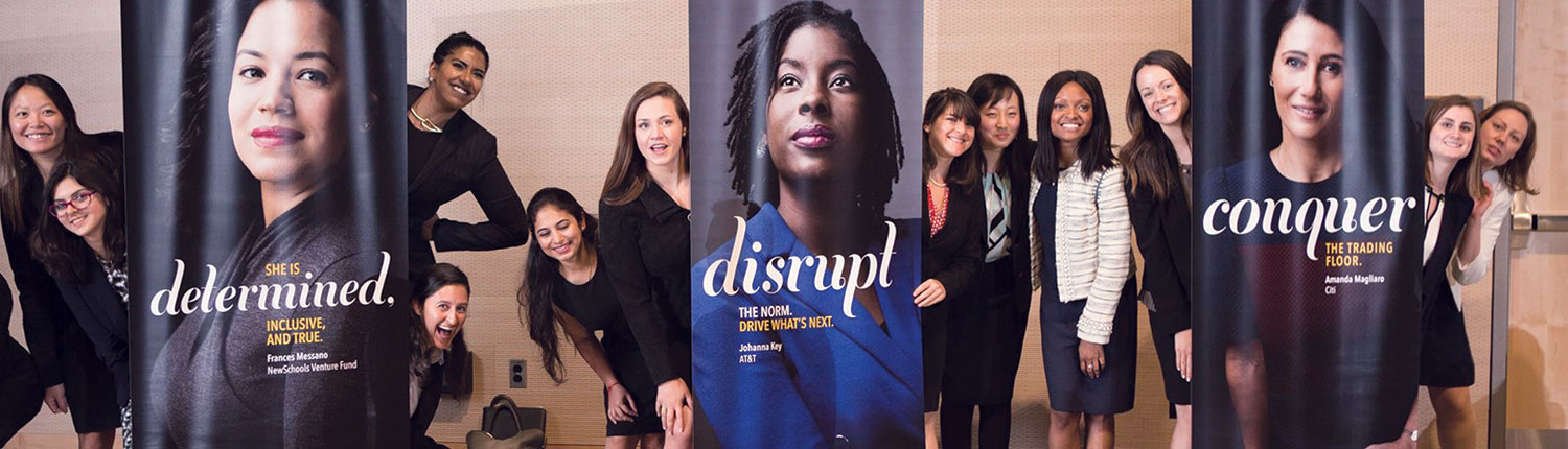 MBA students posing with leadership banners