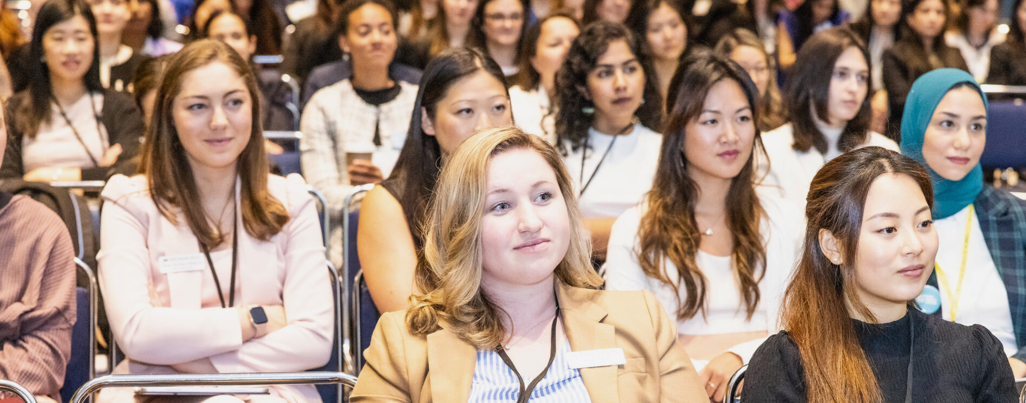 group of MBA women sitting at a conference